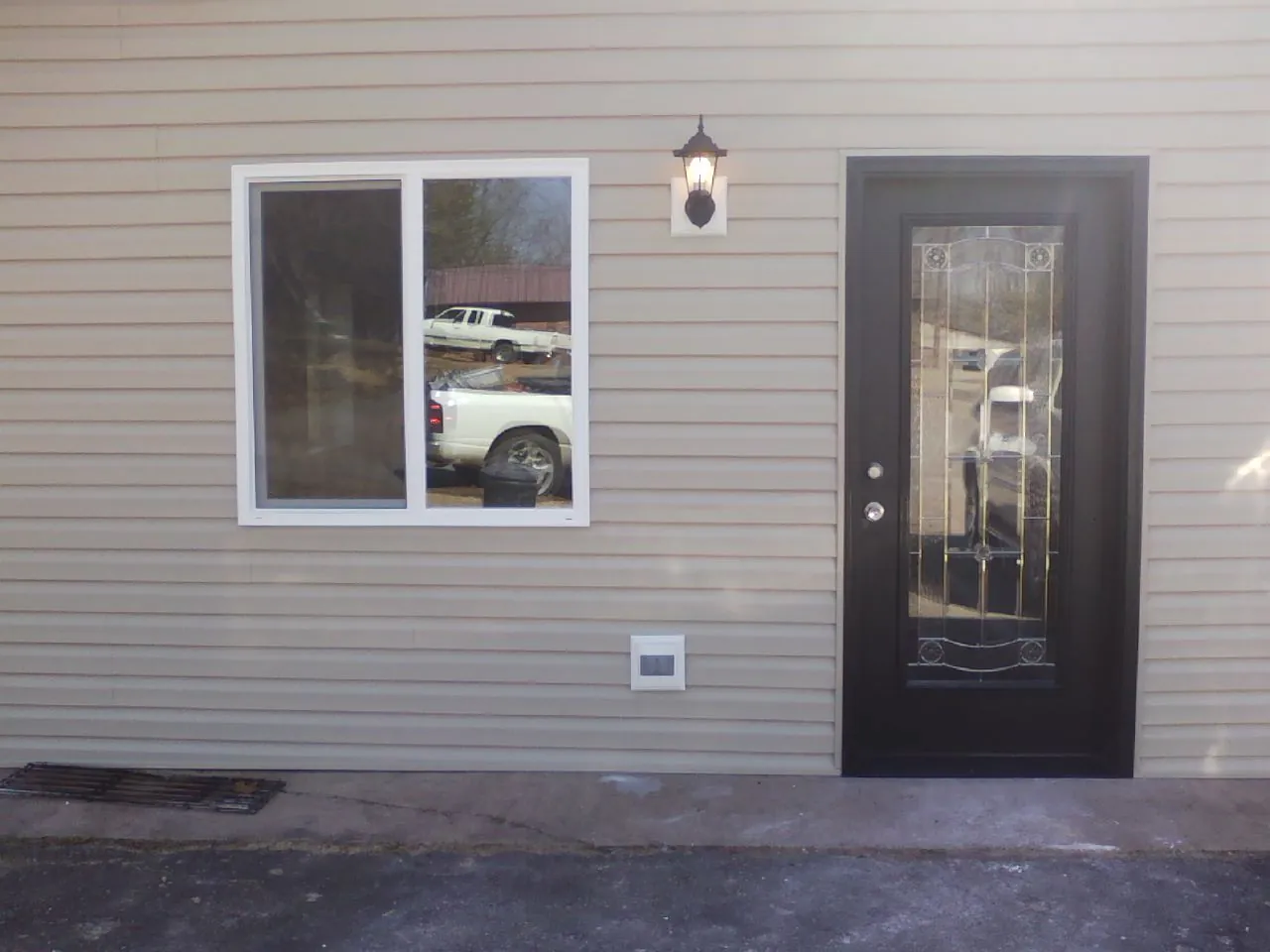New siding, window and entry door on the side of an addition in Marysville